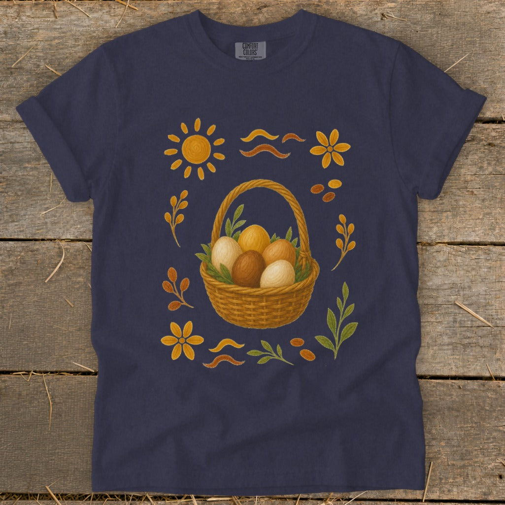 Dark blue t-shirt with Easter basket of eggs, sun, flowers, and leaves design.