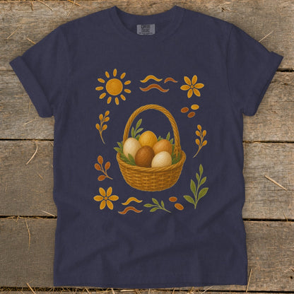 Dark blue t-shirt with Easter basket of eggs, sun, flowers, and leaves design.
