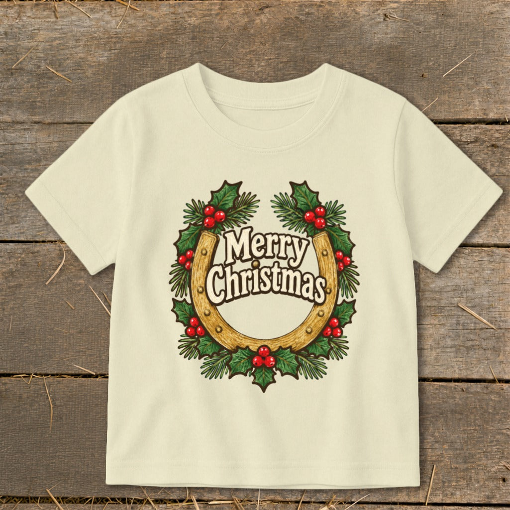 Cream t-shirt with horseshoe, holly, berries, and "Merry Christmas" text.