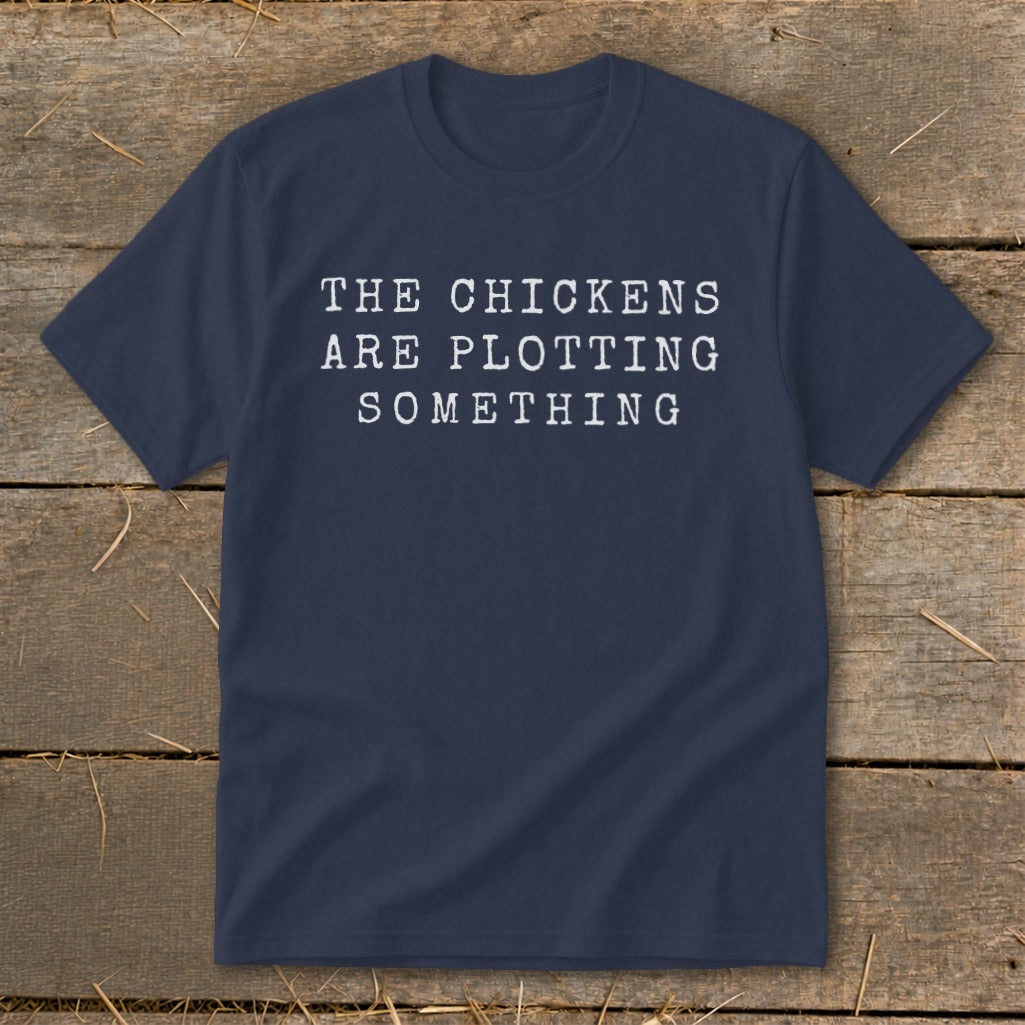 Navy t-shirt with white text "THE CHICKENS ARE PLOTTING SOMETHING".