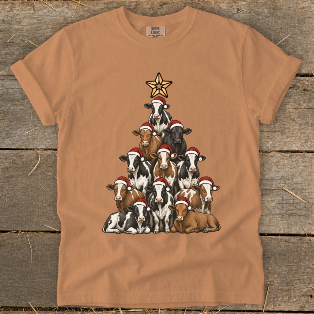 T-shirt featuring a Christmas tree shape made of cows wearing Santa hats.