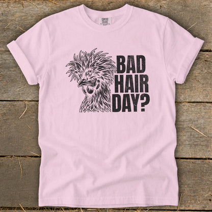 Pink t-shirt with a drawing of a chicken and text "BAD HAIR DAY?".