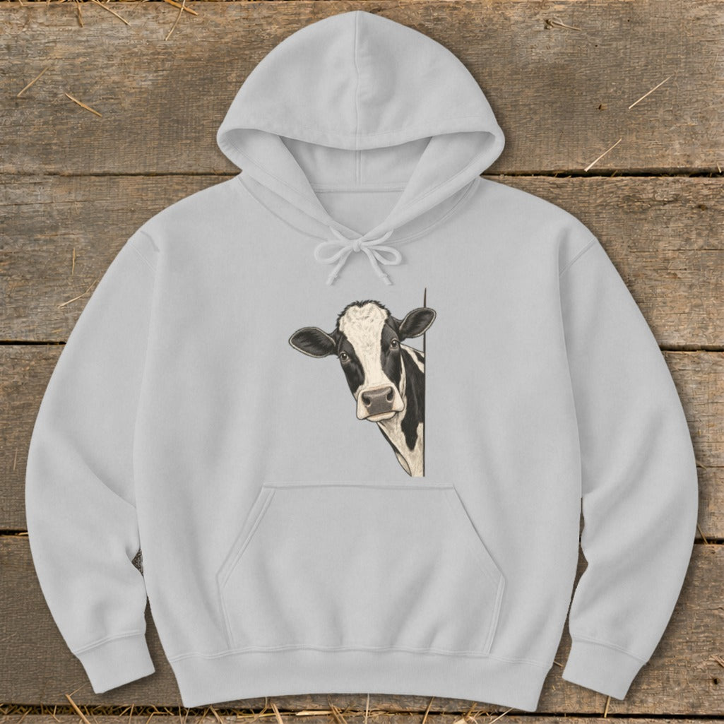 White hoodie with a drawing of a black and white cow peeking from the side.
