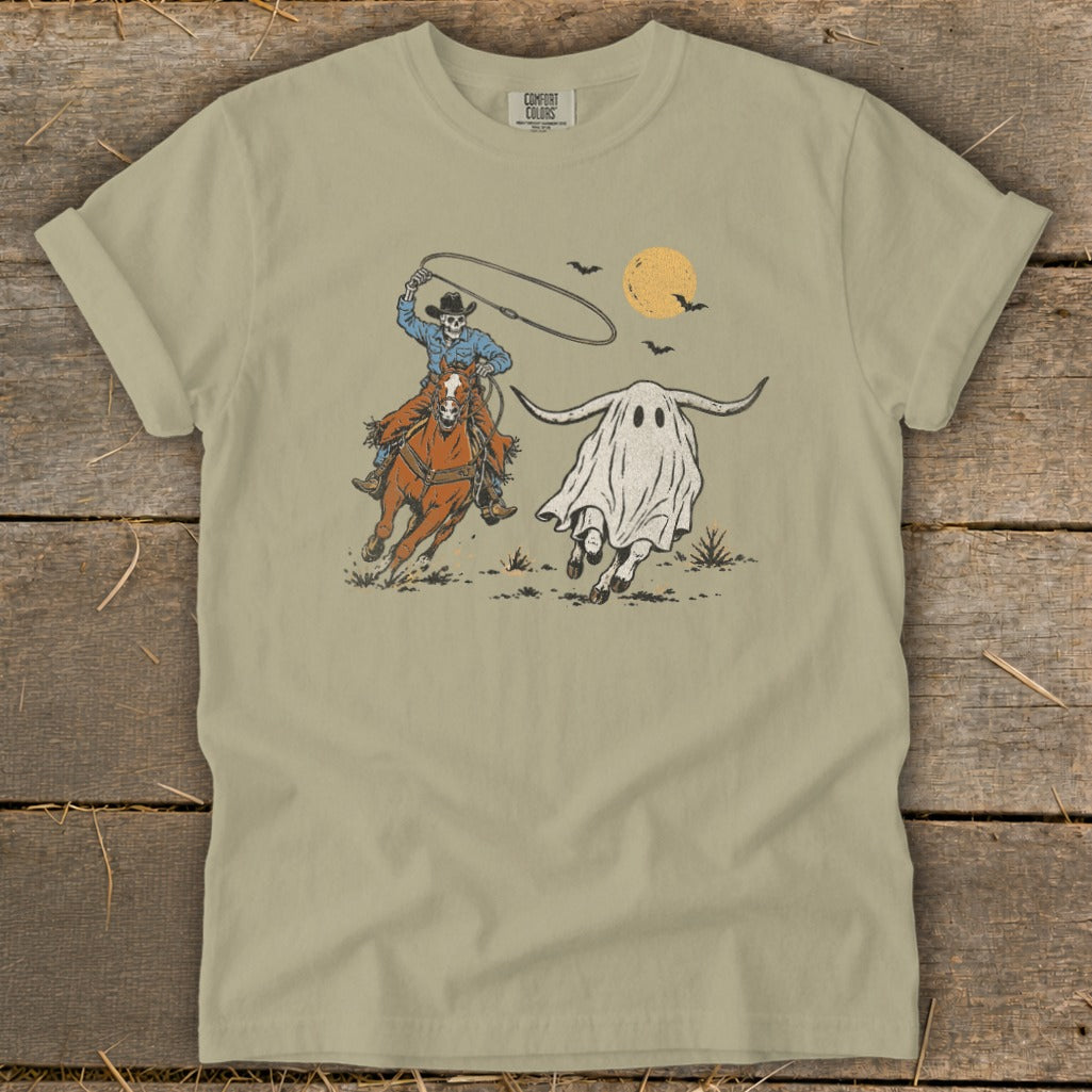 Skeleton cowboy on horseback lassoing a longhorn bull ghost with bats and moon overhead.