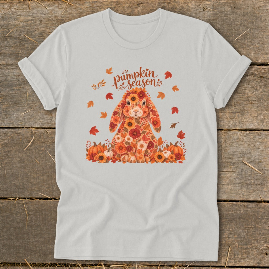 White t-shirt with floral bunny graphic and "pumpkin season" text surrounded by autumn leaves.