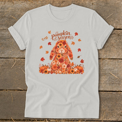 White t-shirt with floral bunny graphic and "pumpkin season" text surrounded by autumn leaves.