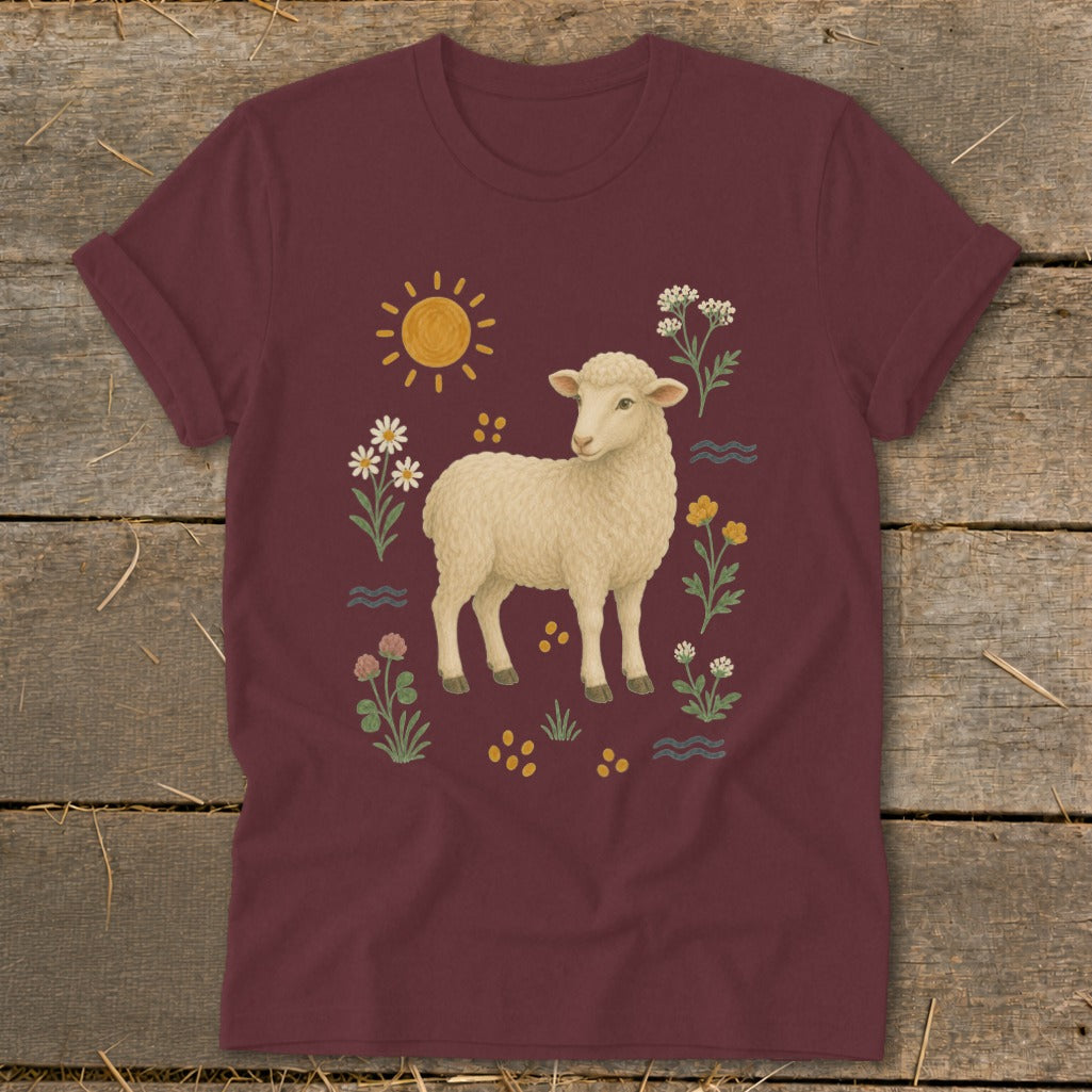 Maroon t-shirt with a cream sheep surrounded by flowers and a sun.