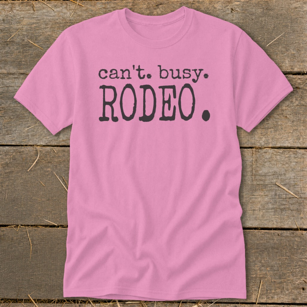 Pink t-shirt with black text "can't. busy. RODEO."