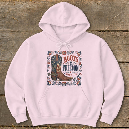 Pink hoodie with "Boots & Freedom Since 1776" graphic featuring a cowboy boot.