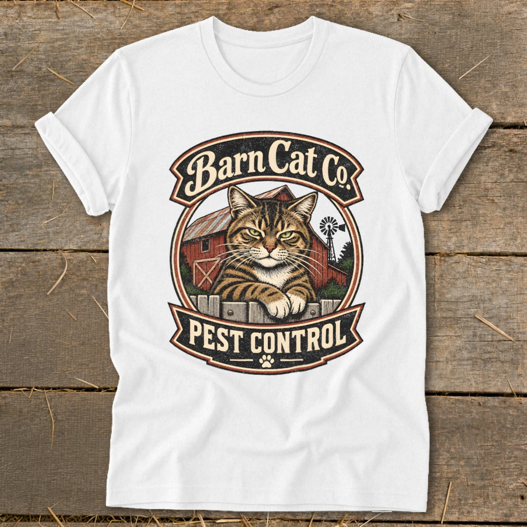 A white t-shirt featuring a vintage logo with a tabby cat, a red barn, and the text Barn Cat Co. Pest Control.