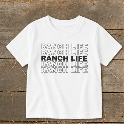 A white short-sleeved t-shirt with five rows of repeated black text reading RANCH LIFE.