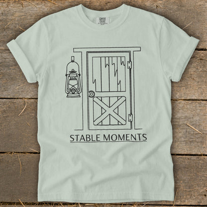 Light green t-shirt with barn door illustration and "Stable Moments" text.