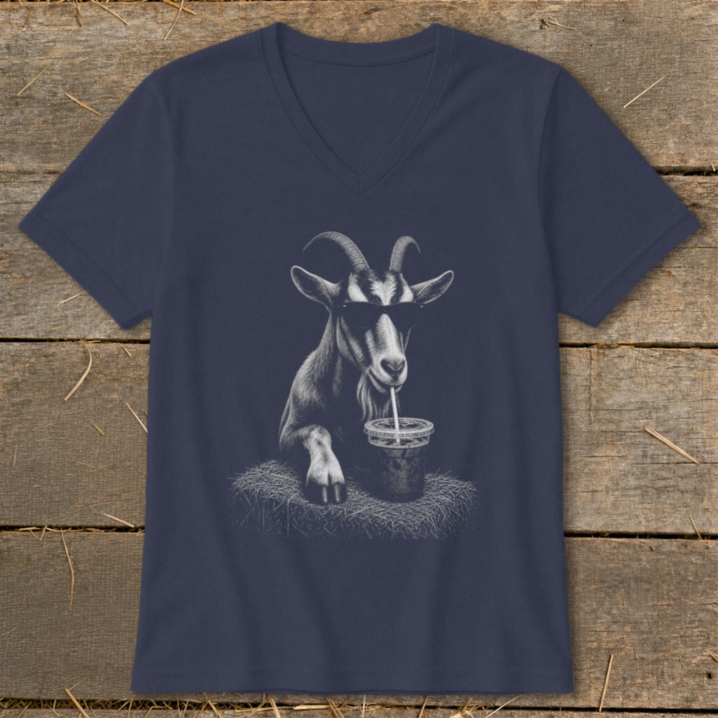 Goat wearing sunglasses drinks from a cup with a straw on a dark t-shirt.