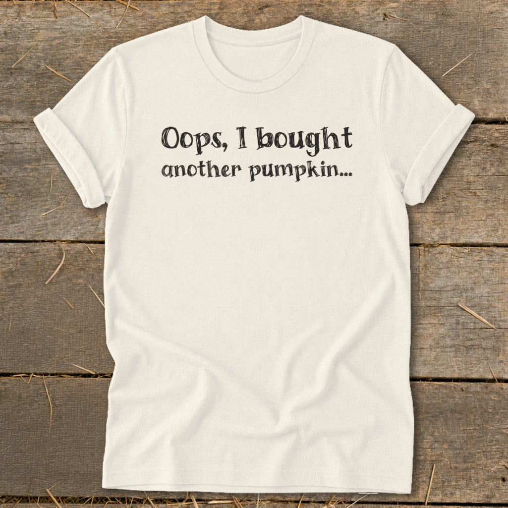 Cream t-shirt with black text that reads "Oops, I bought another pumpkin...".