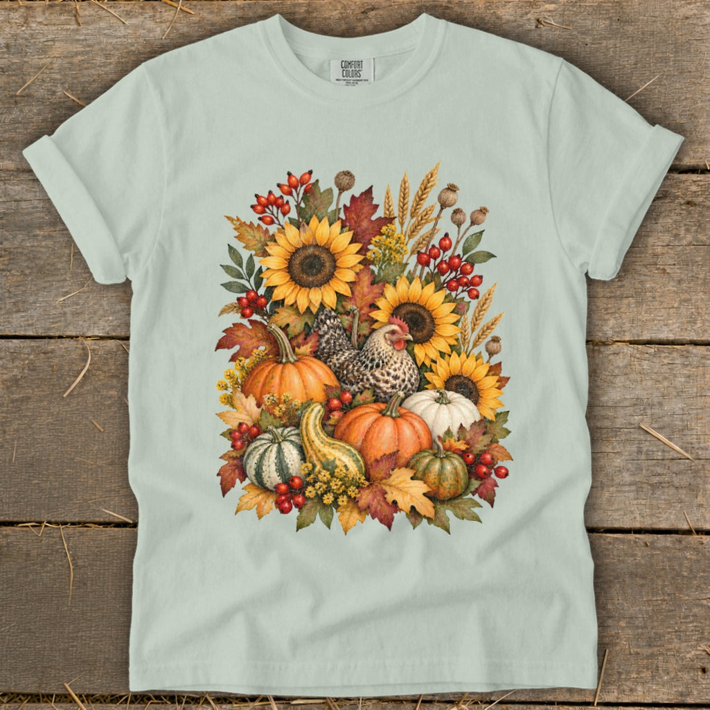 Light green t-shirt with a fall harvest graphic featuring sunflowers, pumpkins, and a chicken.