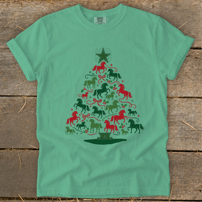Green t-shirt with a Christmas tree design made of red and green horses and holly.
