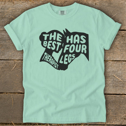 Mint t-shirt with black graphic text "The Best Therapist Has Four Legs".