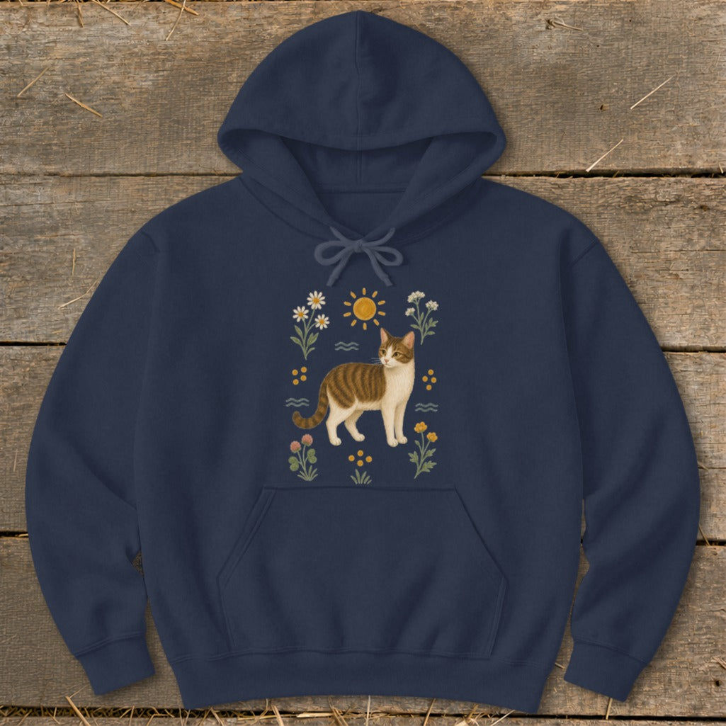 Navy hoodie with a tabby cat illustration surrounded by flowers and a sun.