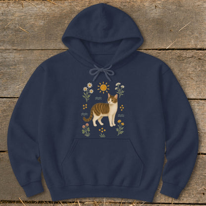 Navy hoodie with a tabby cat illustration surrounded by flowers and a sun.
