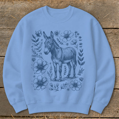 Light blue crewneck sweatshirt with a detailed sketch of a donkey surrounded by flowers.