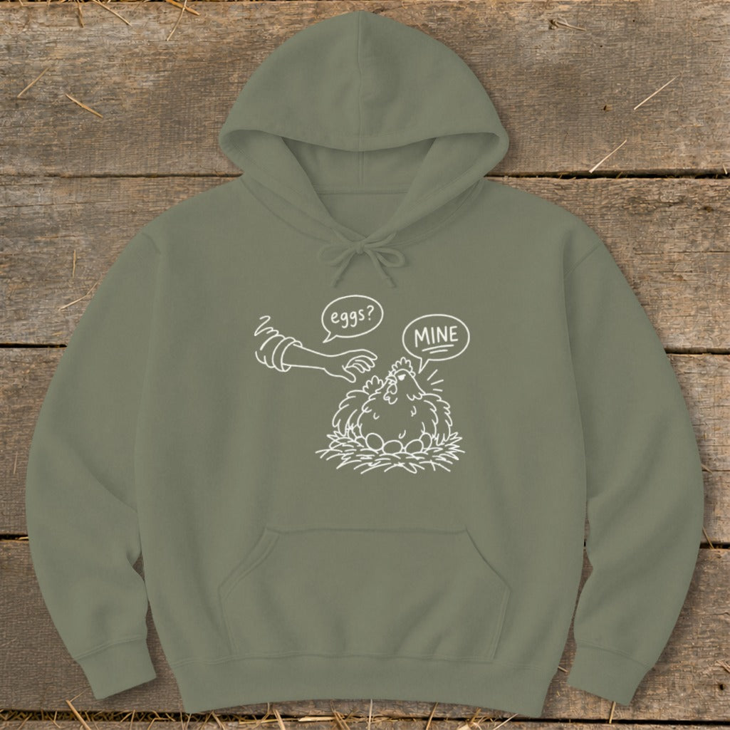 Olive hoodie with a white line drawing of a hen protecting eggs with speech bubbles "eggs?" and "MINE".