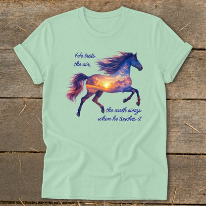 Light green t-shirt featuring a galloping horse silhouette filled with a sunset sky graphic and inspirational text.