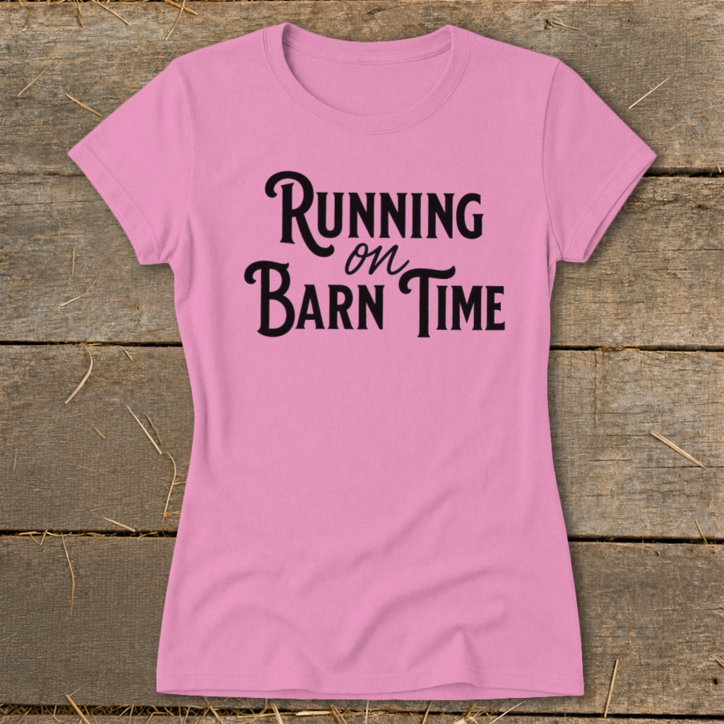 Pink t-shirt with "Running on Barn Time" text in black script.