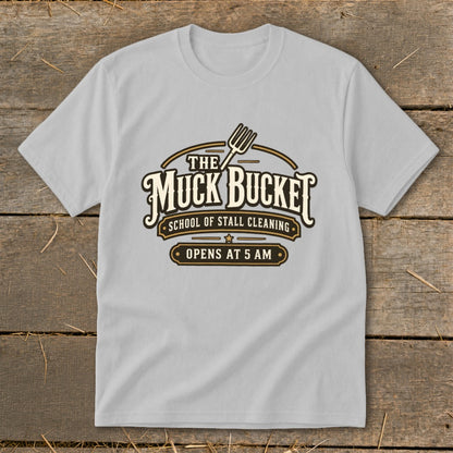Grey t-shirt with "The Muck Bucket School of Stall Cleaning" logo.