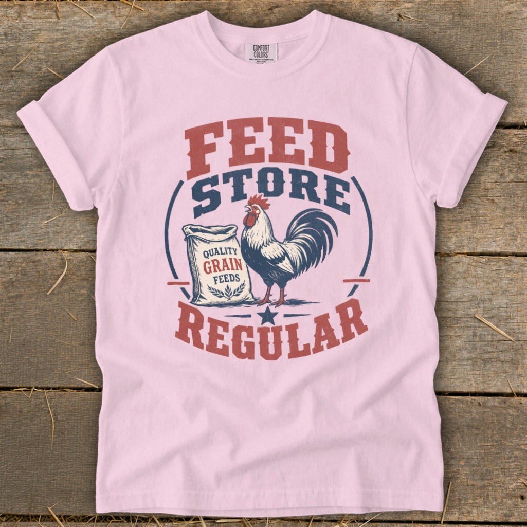 Pink t-shirt graphic with rooster and "Feed Store Regular" text.