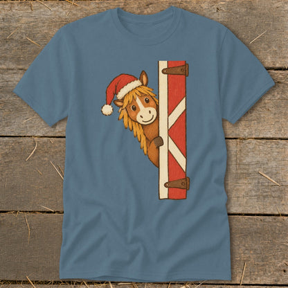 Cartoon horse wearing a Santa hat peeks from behind a red barn door.