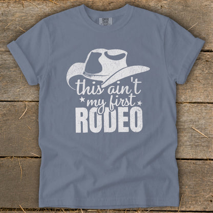 Grey t-shirt with white cowboy hat graphic and text "this ain't my first RODEO".