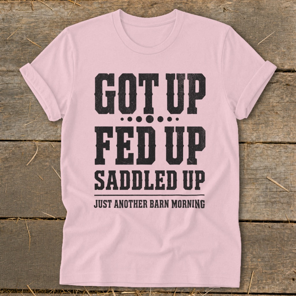 Pink t-shirt with black text "GOT UP FED UP SADDLED UP JUST ANOTHER BARN MORNING".