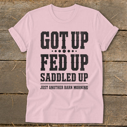 Pink t-shirt with black text "GOT UP FED UP SADDLED UP JUST ANOTHER BARN MORNING".