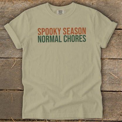 Tan t-shirt with "SPOOKY SEASON" in orange and "NORMAL CHORES" in green text.