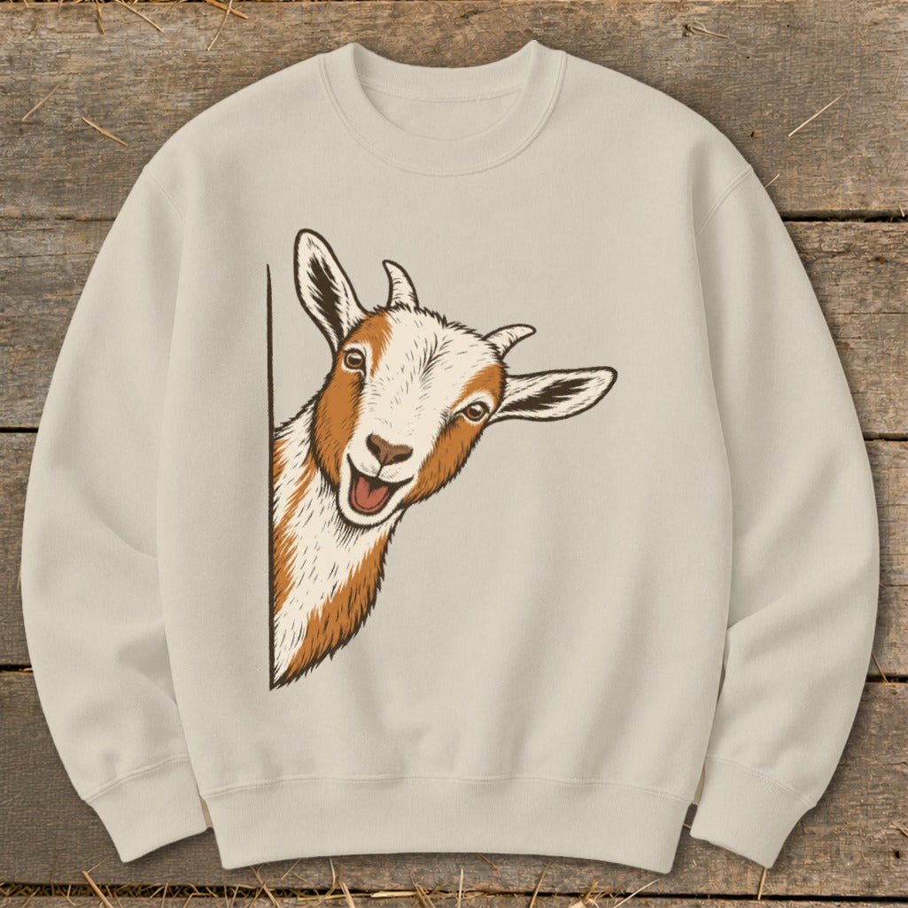 Cream sweatshirt featuring a playful illustration of a goat peeking from the side.