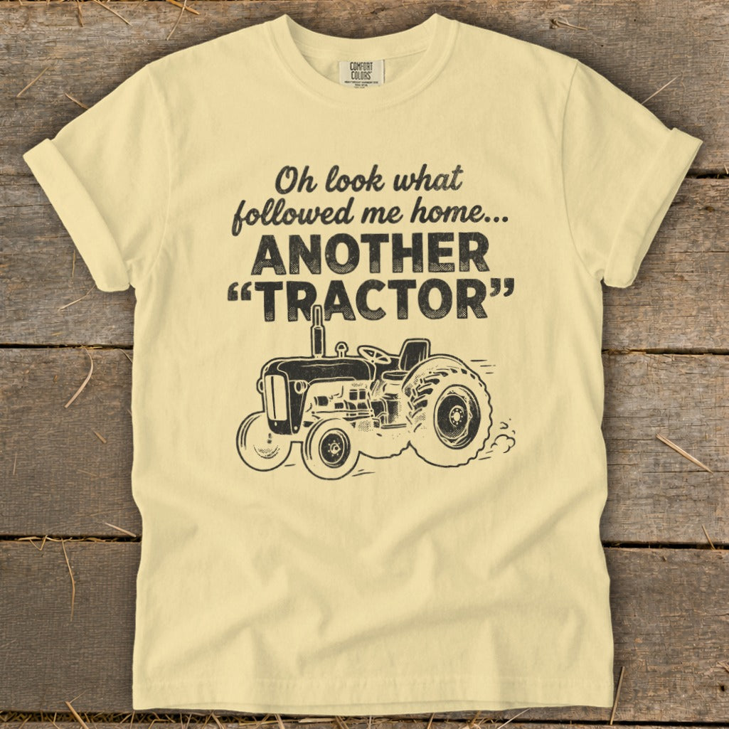Light yellow t-shirt with "Oh look what followed me home... ANOTHER 'TRACTOR'" and tractor graphic.