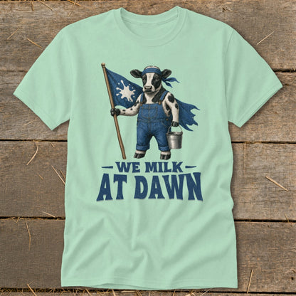 Cow wearing overalls and cape holding a flag and milk pail, text "We Milk At Dawn".