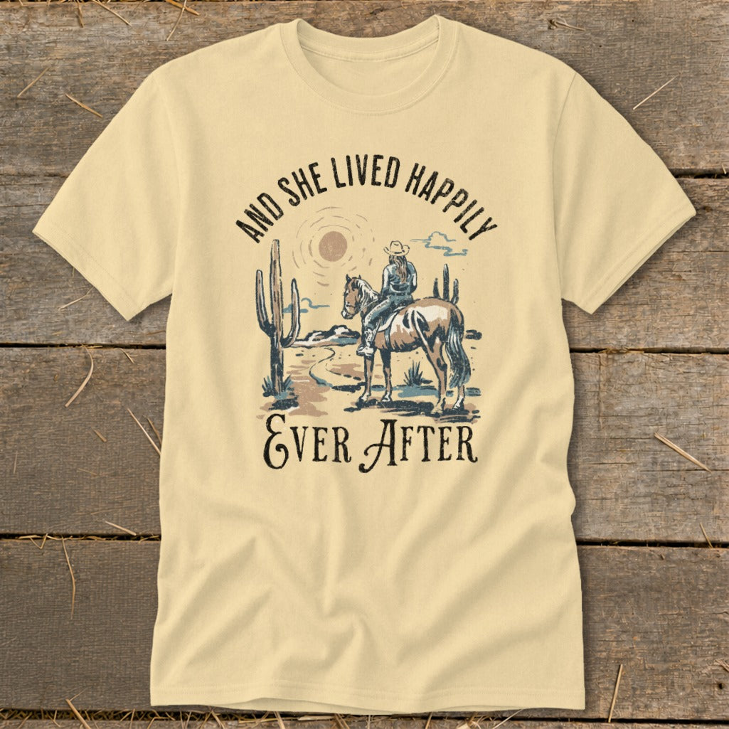 Cowgirl on horse in desert scene with cacti and text "And She Lived Happily Ever After".