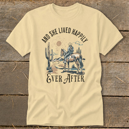Cowgirl on horse in desert scene with cacti and text "And She Lived Happily Ever After".