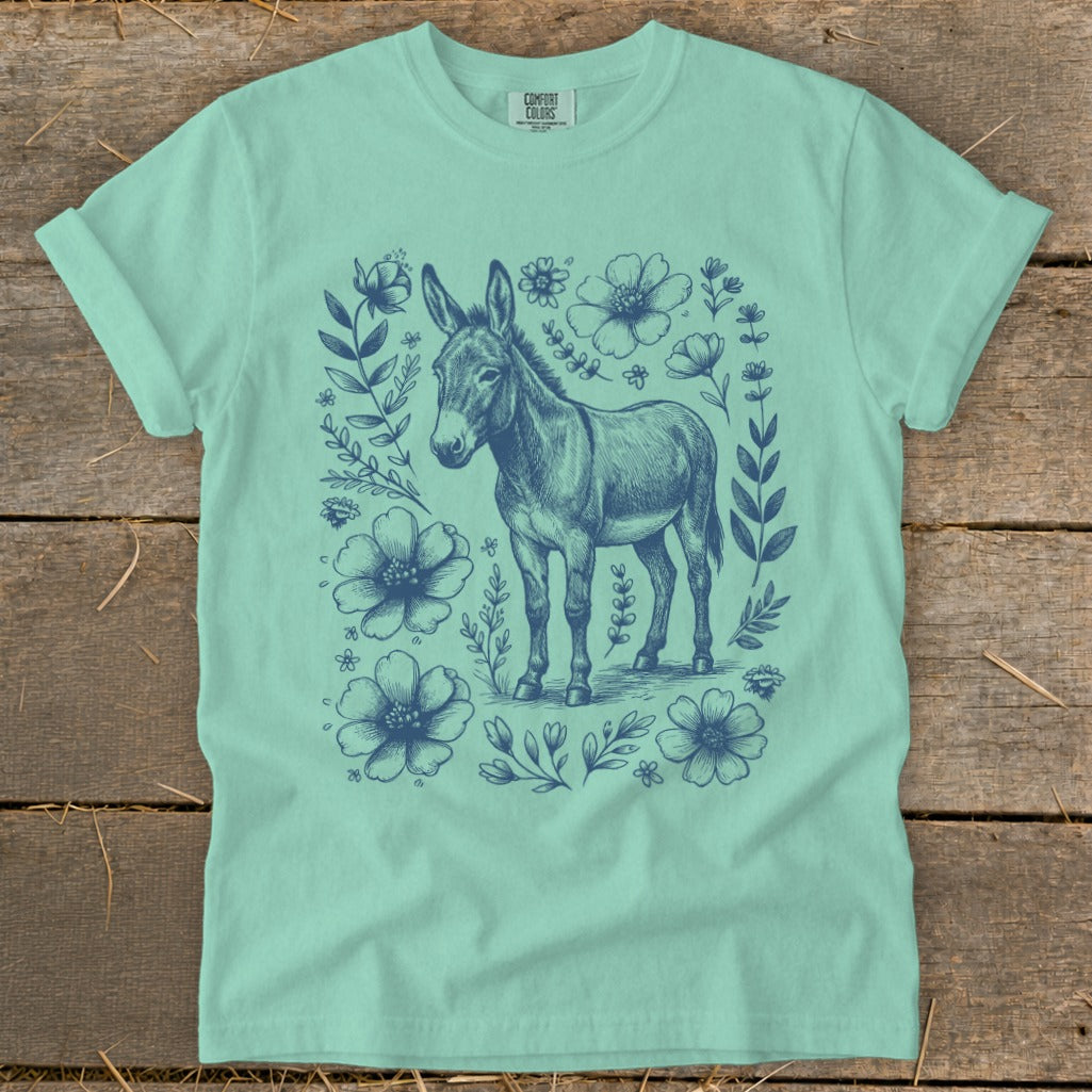 Mint green t-shirt with blue donkey and floral sketch graphic.