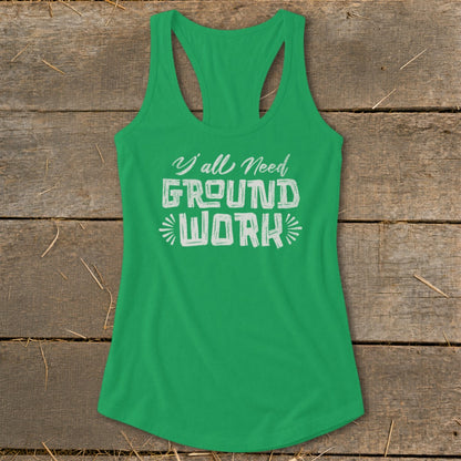 Green tank top with white text reading "Y'all Need GROUND WORK"