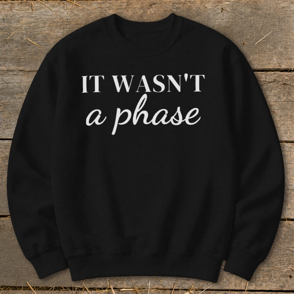 Black sweatshirt with white text "IT WASN'T a phase".