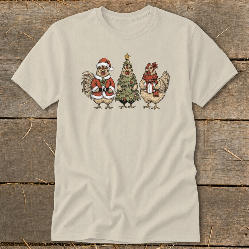 Three cartoon chickens in festive holiday attire on a tan t-shirt.