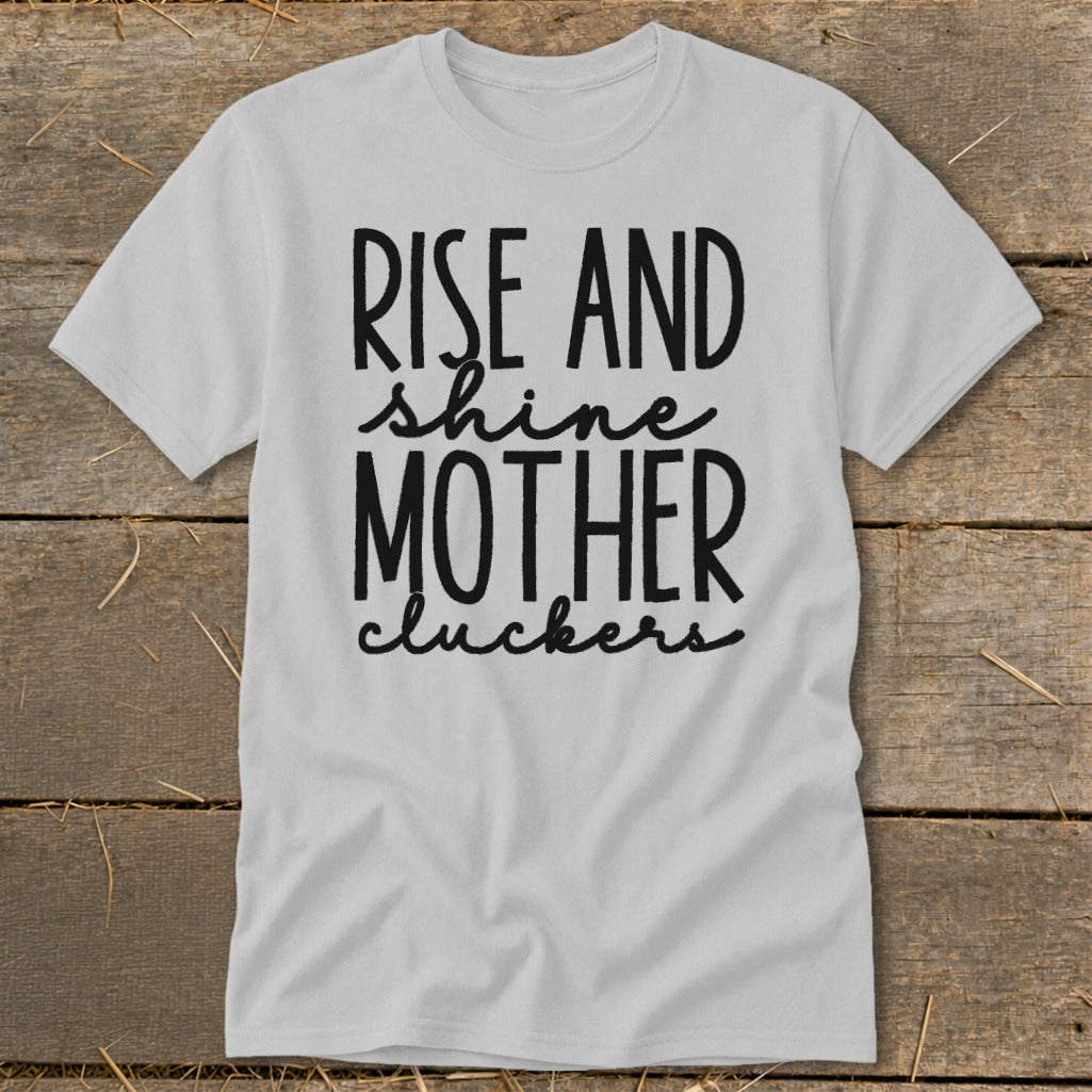 Light gray t-shirt with black text "Rise and shine mother cluckers".