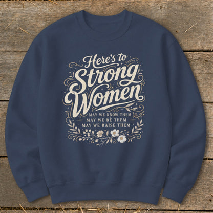 Navy sweatshirt with "Here's to Strong Women" and floral design.