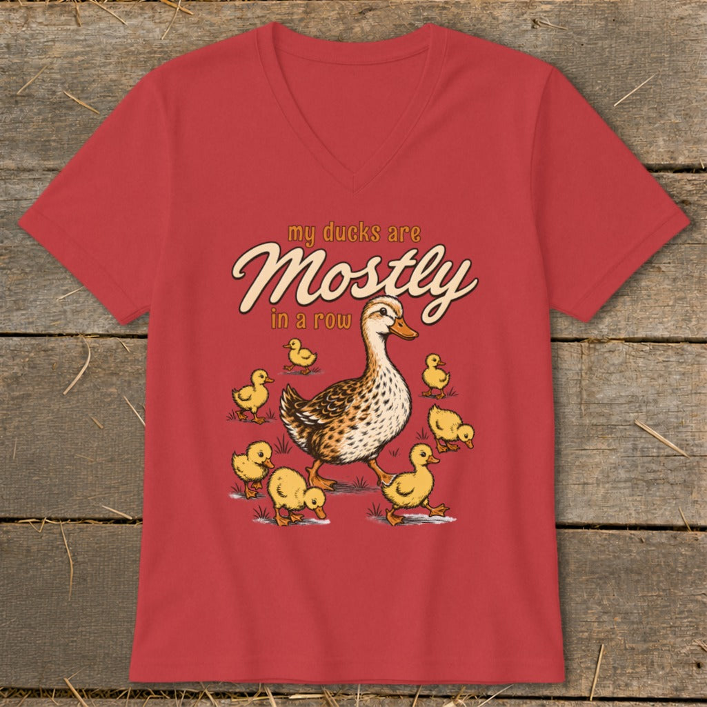 Red t-shirt with illustration of a mother duck and ducklings, text "my ducks are Mostly in a row".