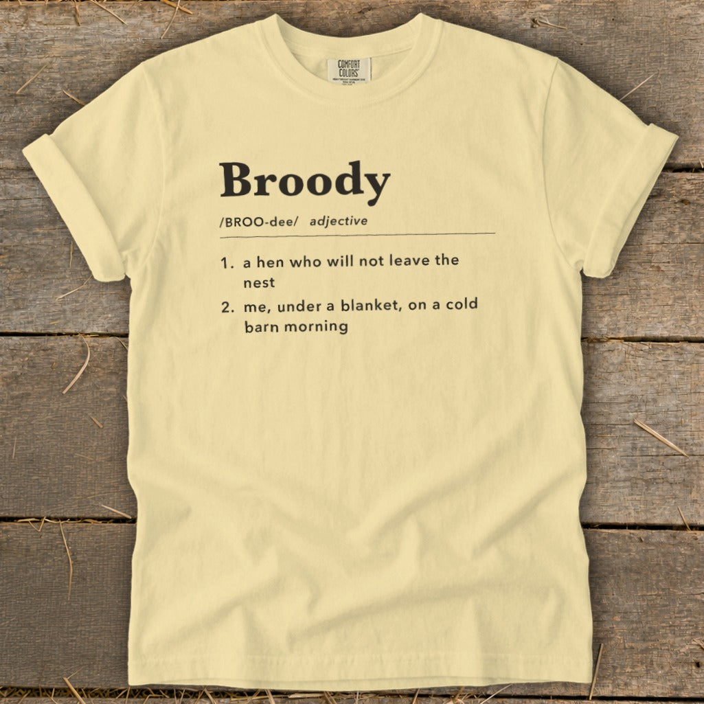 Light yellow t-shirt with "Broody" definition: "a hen who will not leave the nest" and "me, under a blanket, on a cold barn morning".