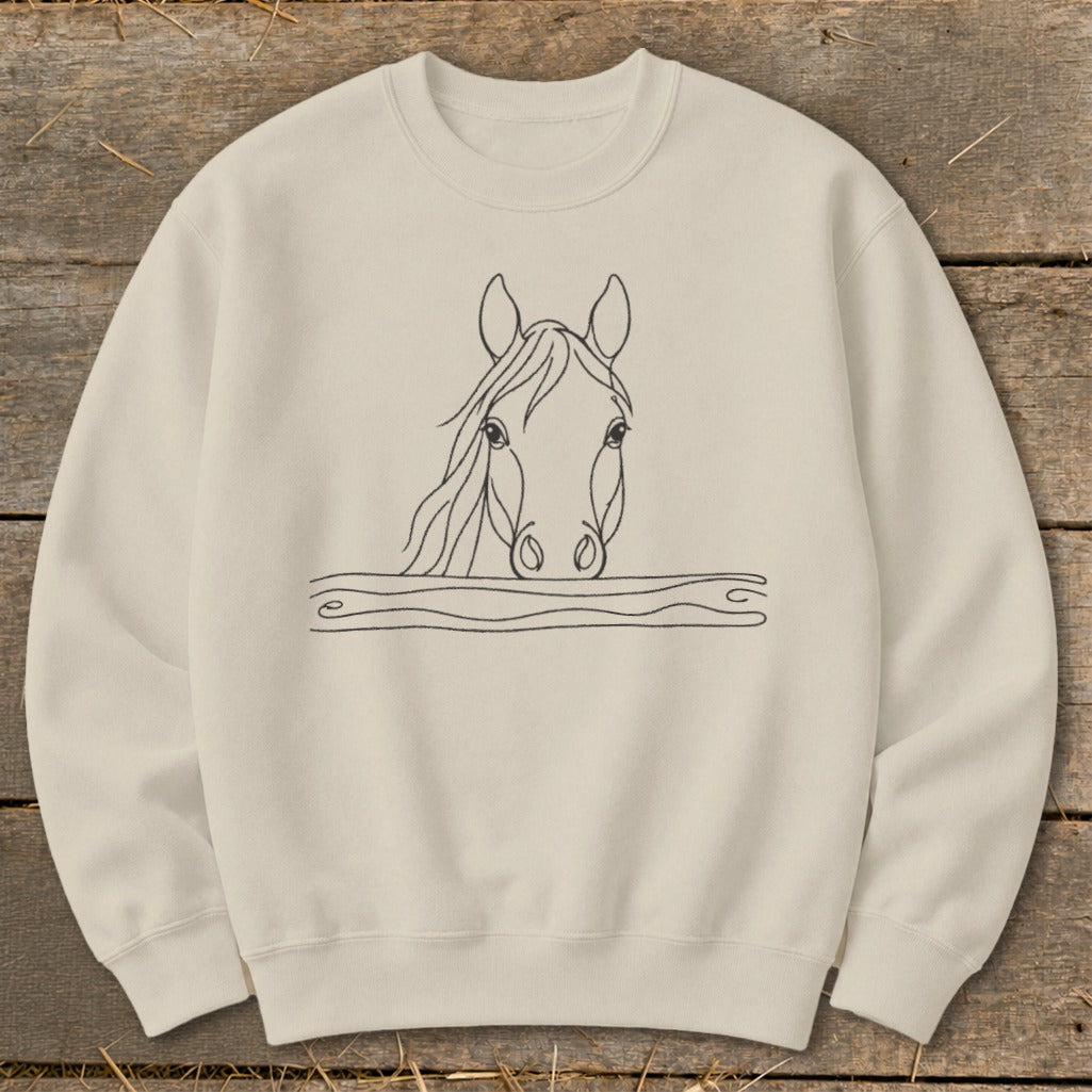 Cream sweatshirt with a black line drawing of a horse's head peering over wavy lines.