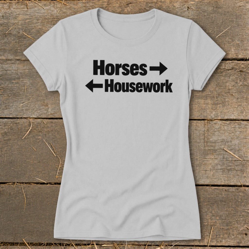 Light gray women's t-shirt featuring black text reading "Horses" with a right arrow and "Housework" with a left arrow.