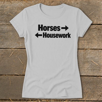 Light gray women's t-shirt featuring black text reading "Horses" with a right arrow and "Housework" with a left arrow.